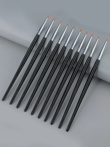 Detailed macro view of professional 10-piece fine eyeliner brushes with orange synthetic tips