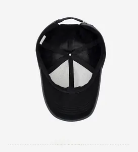 Detail view of the black baseball cap interior with reinforced seams and adjustable strap