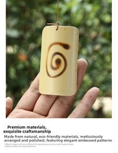 Detail of handcrafted bamboo wind chime pendant with elegant burnt spiral pattern