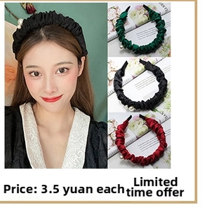 Detail of velvet pleated headband with pearl accents in black, green, and red colors