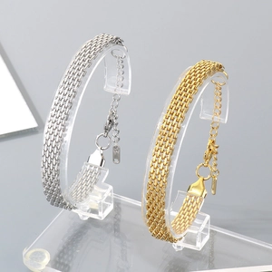 Bracelet de tennis large en maille d'acier inoxydable avec finitions or et argent
