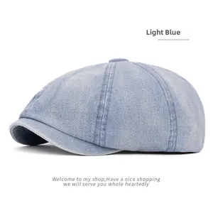 Detail of light blue washed denim newsboy cap featuring multi-panel stitching and top button