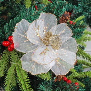 White mesh Christmas flower with gold glitter on a festive tree background