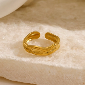Irregular organic wave pattern adjustable gold plated ring on white stone background