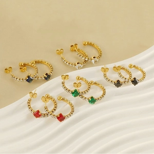 Detail of 18k gold plated hoop earrings set with colorful square zircons and small crystals