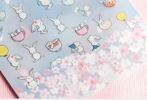 Detail of 5D embossed white bunny nail stickers with pink cherry blossoms and KX028 code