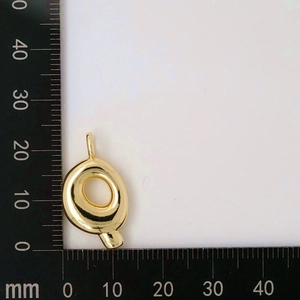 Close-up of golden letter Q bubble pendant showing 22mm height measurement on a ruler