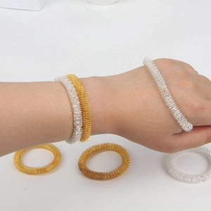 Elastic spring massage bracelets in gold and silver steel for wrist pressure relief