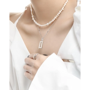 Elegant S925 sterling silver necklace with geometric pendant and luxury pearls on a model