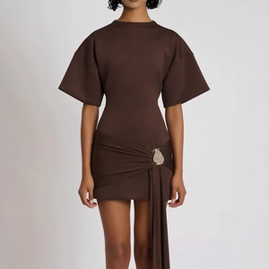 Detail view of dark brown mini dress with side pleats and rhinestone buckle decoration