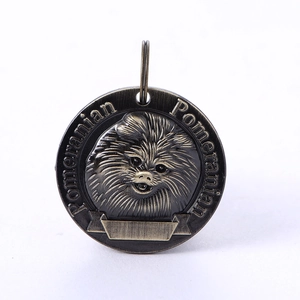 Macro shot of bronze Pomeranian dog ID tag with vintage 3D relief and engraving area