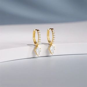 Macro shot of gold-plated S925 silver hoop earrings with diamond accents and rhombic stone
