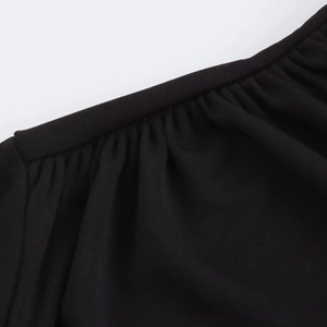 Macro view of high-quality pleated knit fabric with fine stitching on black dress
