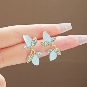 French leaf earrings with blue enamel and clear crystals on a gold metal base