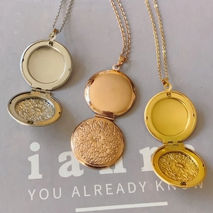 Embossed lotus stainless steel locket necklace in silver, rose gold, and gold finishes