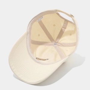Internal view of cream cotton baseball cap showing reinforced seams and washing label