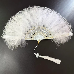 Detail of white feather folding fan with lace trim and elegant white tassel
