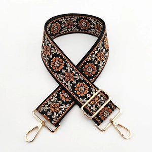 Close-up of ethnic floral embroidery texture on 5cm wide shoulder strap with gold hooks