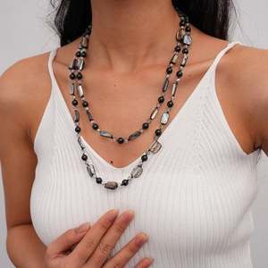 Detail of layered shell and crystal beaded long necklace with black stones and silver finish