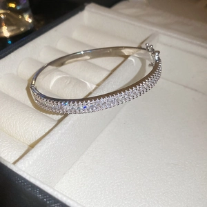 Close-up of silver-tone double-row zircon pavé bracelet with a secure buckle in a gift box