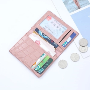Pink crocodile pattern leather card holder with multiple slots on a clean white background