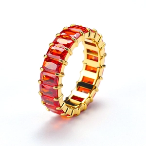 Detail of gold-plated titanium steel ring with rectangular ruby-style cubic zirconia