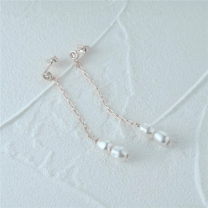 Detail of s925 silver stamp on luxury long tassel earrings with drop pearls