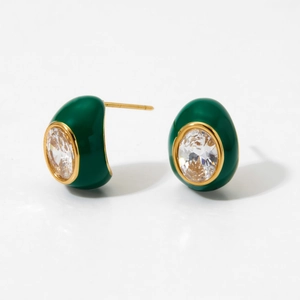 Close-up of gold stud earring with green enamel and oval cubic zirconia crystal