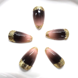 Brown gradient almond press-on nails with luxury gold glitter accents in set of five