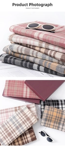 Detailed view of thick plaid scarves in multiple colors with soft knitted texture