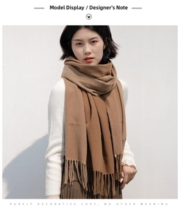 Detailed texture of brown cashmere-style scarf with elegant tassels for winter wear