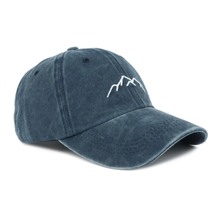 Detail of navy blue washed denim baseball cap featuring minimalist mountain embroidery