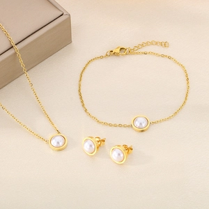 Détail de la parure de bijoux dorée en acier titane avec collier, bracelet et perles