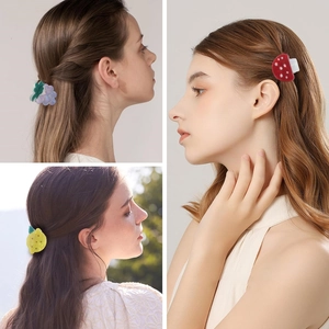 Three-grid display of fruit hair clips featuring grape, lemon, and mushroom designs on hair