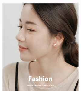 Close-up of S999 silver star stud earring worn on model's ear