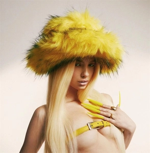 Close-up of bright yellow faux fur bucket hat with black tips and fluffy texture