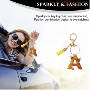 Detailed view of Letter A keychain with honeycomb pattern, yellow tassel, and lobster clasp
