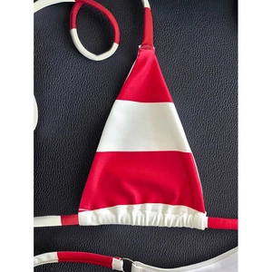 Detail of red and white striped halter bikini top with metallic ring and ruched cups