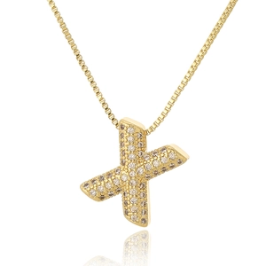 Macro shot of gold letter X pendant with micro-pave cubic zirconia on box chain