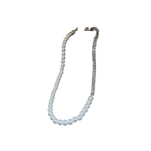 Elegant gold-plated necklace with spliced pearls and zircons on a clean white background