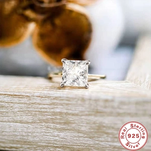 Macro shot of square-cut diamond on a 925 sterling silver band with hallmark detail