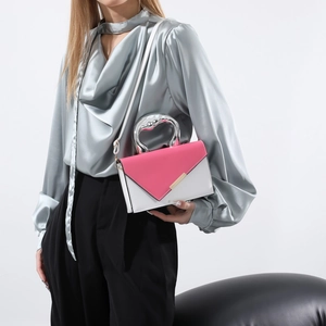 Modern color-block crossbody bag with silver geometric handle and thin white strap