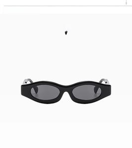 Detail view of oval bright black sunglasses frame with silver metal hinge components