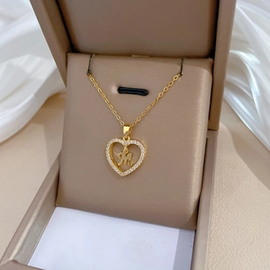 Luxury heart pendant necklace with letter M and pavé crystals on a gold-tone chain