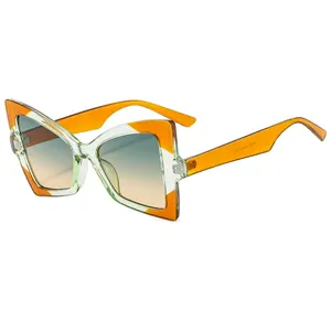 Modern oversized butterfly sunglasses with amber orange frame and gradient lenses