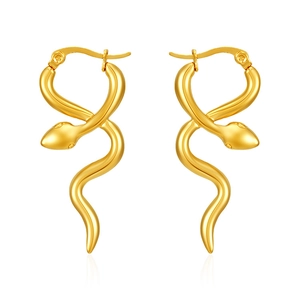 Macro detail of elegant golden snake-shaped earrings with polished finish and curved design