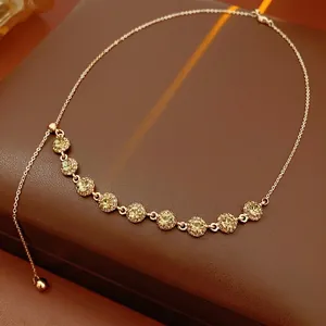 French style gold-plated necklace with circular rhinestones on a leather display box