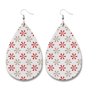Close-up of teardrop leather earrings with red snowflake pattern and litchi texture