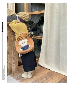 Close-up of quilted caramel crossbody bag featuring a cute bear patch for children