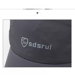 Detailed close-up of quick-dry gray sports cap with logo and textured breathable fabric